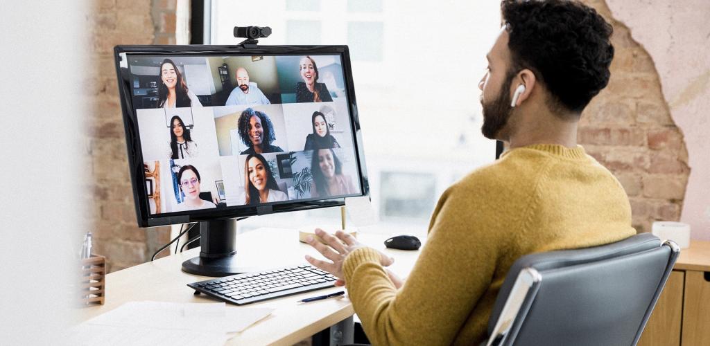 Gentleman working on desktop during a team meeting with team mates