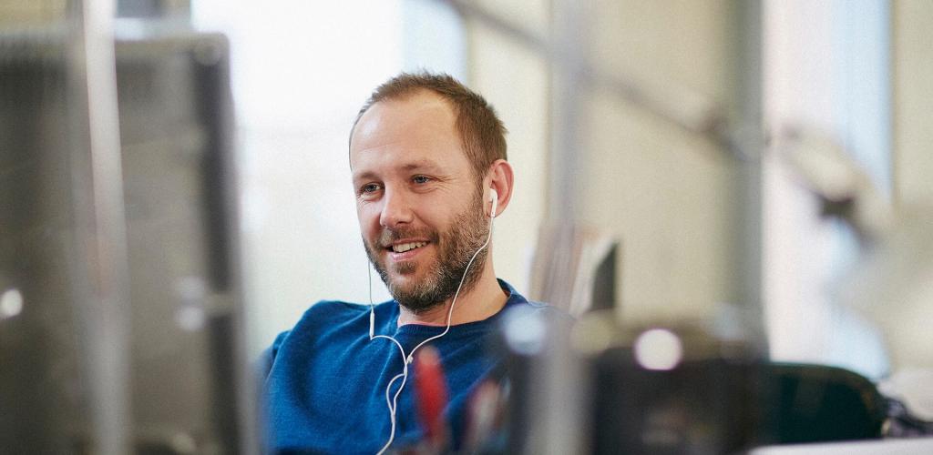 Person sat workiong with ear phones in