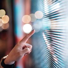 Ladies finger pointing at a big screen