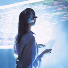 Women looking at screen wall of data