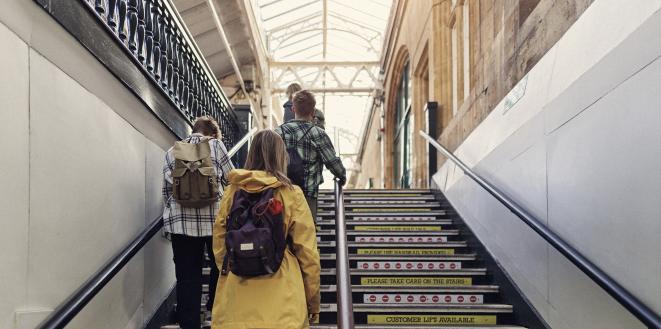 Group of people walking up stairs