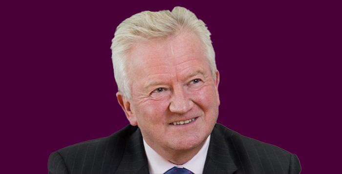 Paul Golby Headshot on purple background 