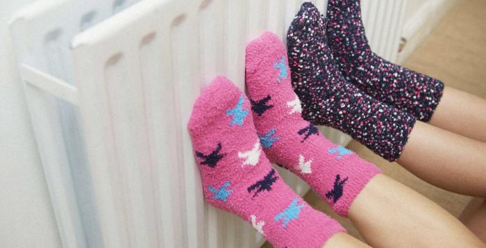 Children with fluffy socks on the radiator 