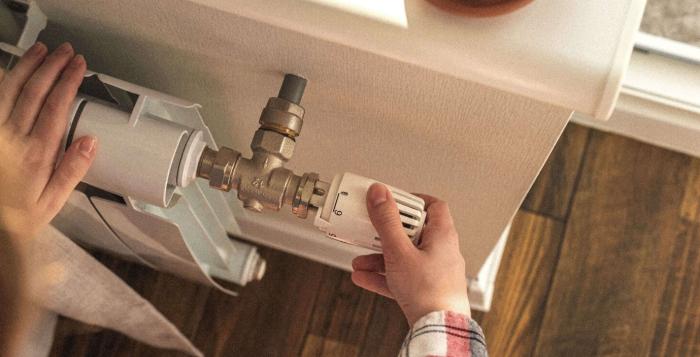 GettyImages-1331509663-person turning heating down