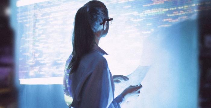 Women looking at screen wall of data