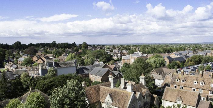 Aerial view over streets, houses and trees in Britain