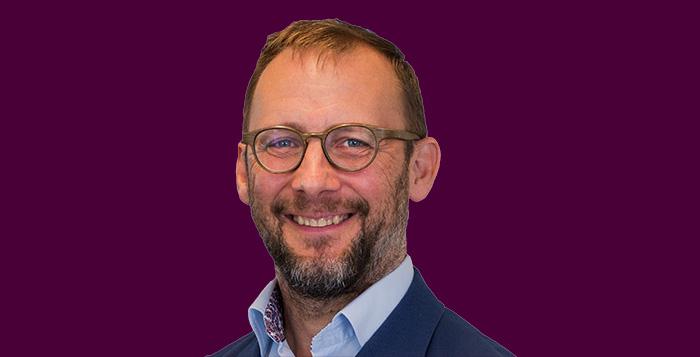 Paul Plummer Headshot on purple background 